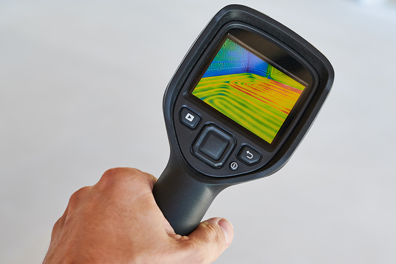 Thermal imagining device being used while preforming home inspection services 